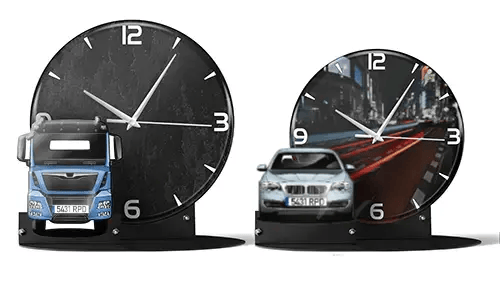 Two decorative clocks with model vehicles: left with black marble face and blue truck, right with cityscape and red sports car