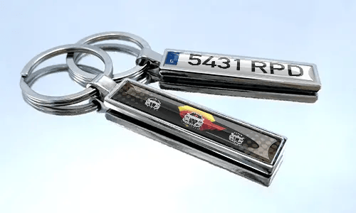 Set of metal comic car keychains with colorful racing vehicle designs