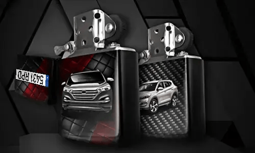Two metallic lighters with silver SUV designs: one front view on tread background, one side view with carbon texture, small rectangular object in corner