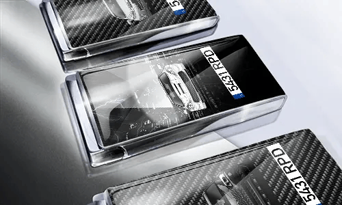 Three car-themed boxes with glossy finish: silver with car, black with cityscape and black car, red with car front